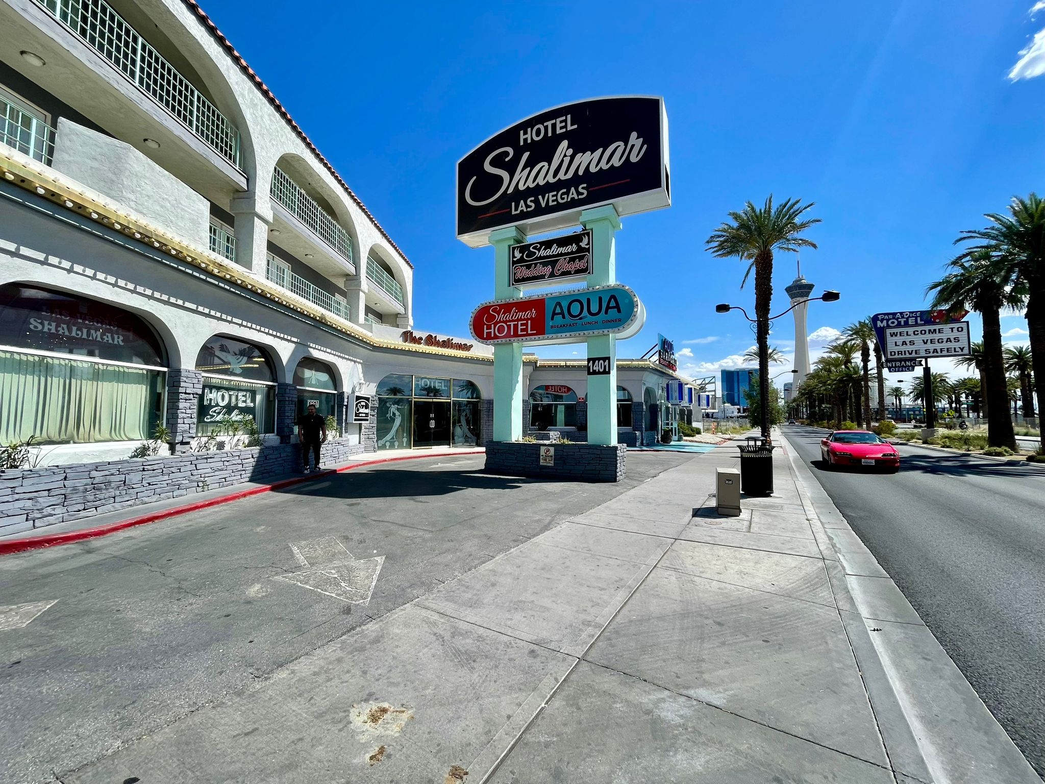 A photograph of the exterior of a hotel with a prominent sign reading 'Hotel Shalimar Las Vegas'.